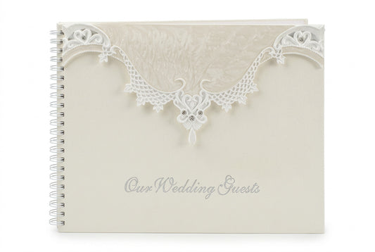 Cream wedding guest book with ornate lace heart cover and “Our Wedding Guests” text
