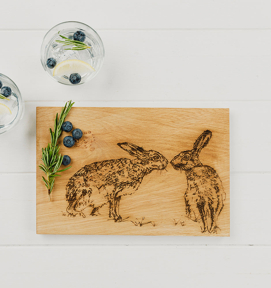 Oak serving and cheese board with engraved kissing hares design