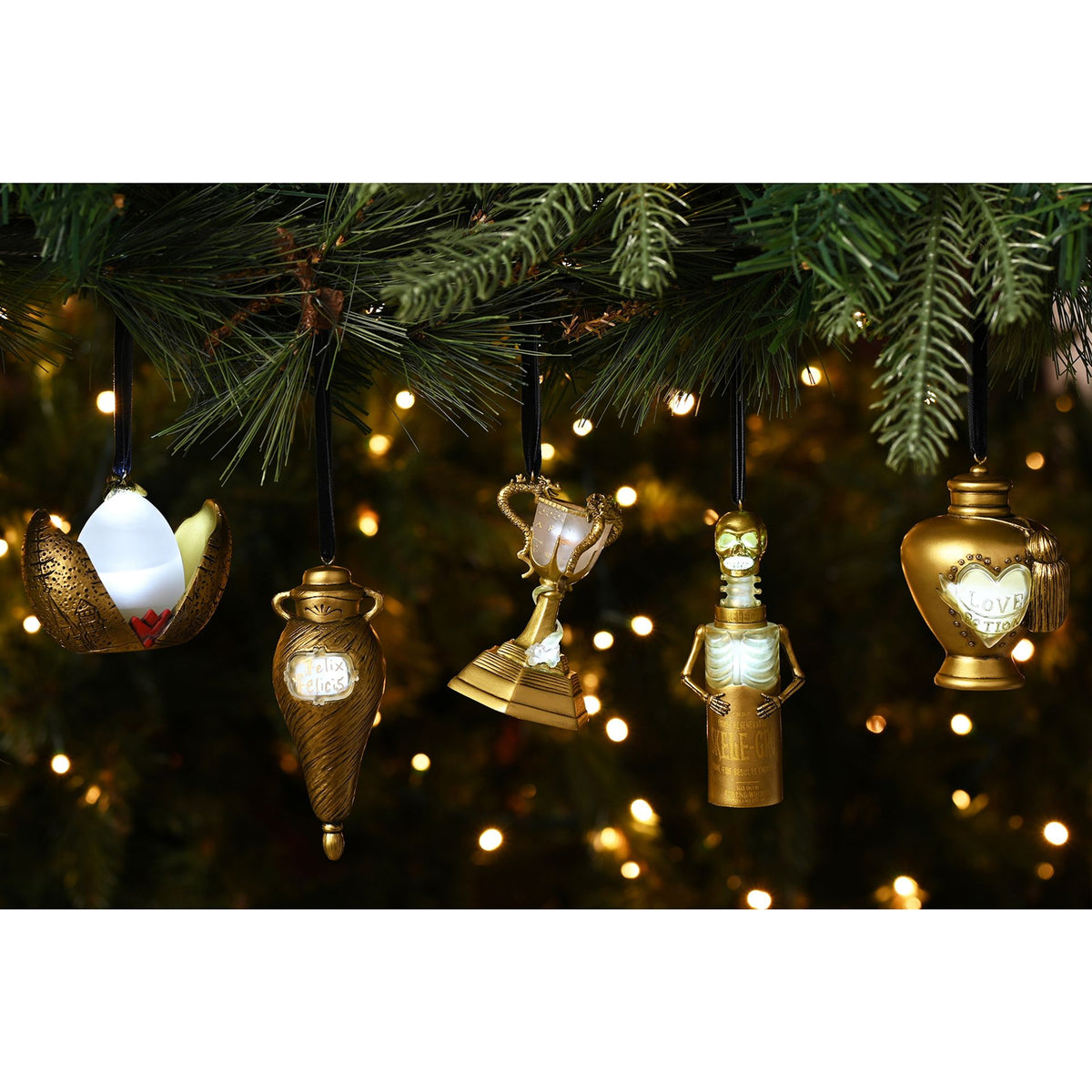 Multiple hanging potion bottle LED ornaments on a Christmas tree branch