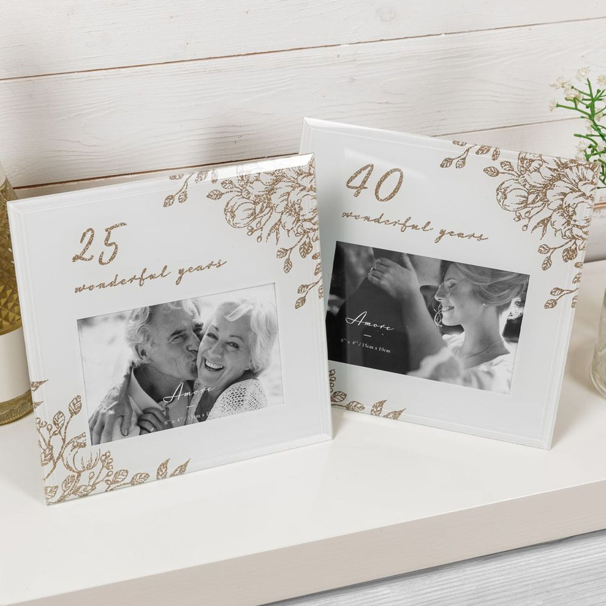 Two pale grey 6x4 photo frames with gold floral designs and anniversary photos