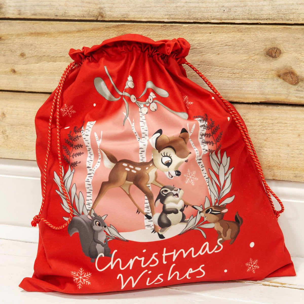 Red drawstring present sack with "Christmas Wishes" text and Disney Bambi woodland scene