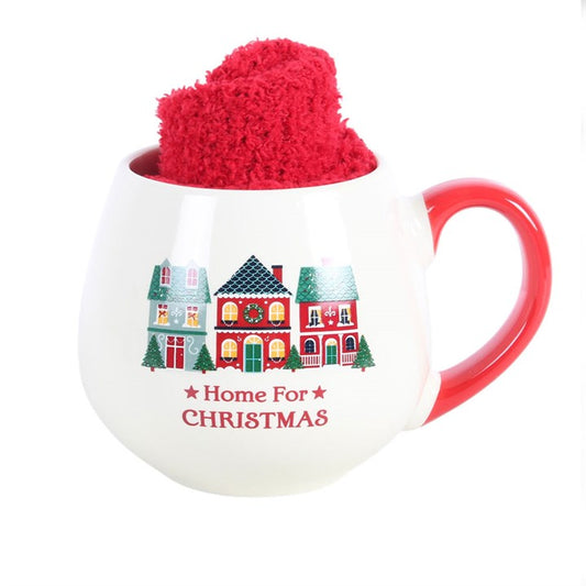 Christmas mug with red handle and fuzzy red topper, house scene and 'Home For Christmas' text.