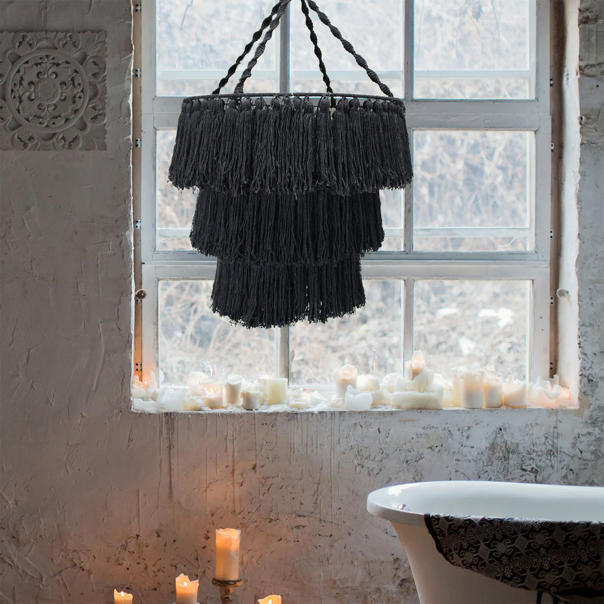 Black macrame chandelier with hanging fringe tiers and braided suspension cords