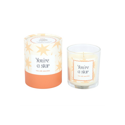 Star-themed scented candle with glass jar and “You’re a star” label, small wick visible