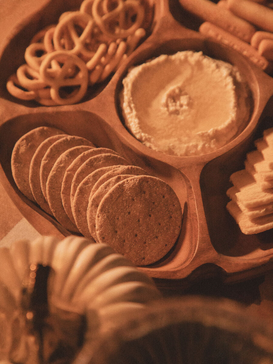 Acacia wood five-section serving dish with slices arranged in side compartments