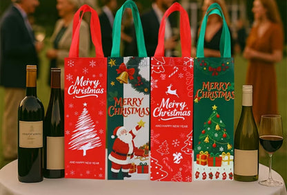Four festive Christmas gift bags with red and green handles stand on a table outdoors, styled with wine bottles and a glass of red wine. The bags feature holiday illustrations including Santa Claus, Christmas trees, and gifts, with 'Merry Christmas' printed on them.
