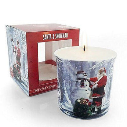 Scented candle with Santa and snowman design next to its packaging on a white background