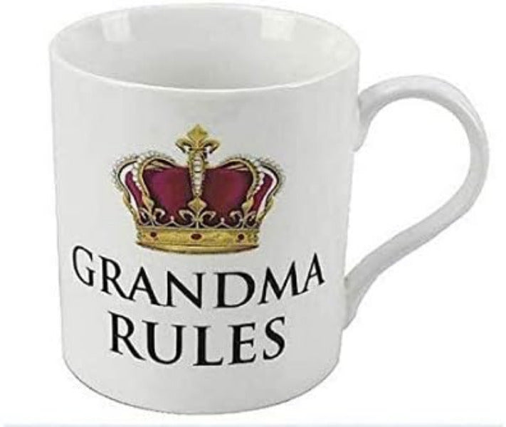 A white ceramic mug featuring a printed gold and purple crown graphic above the words 'GRANDMA RULES' in black capital letters.