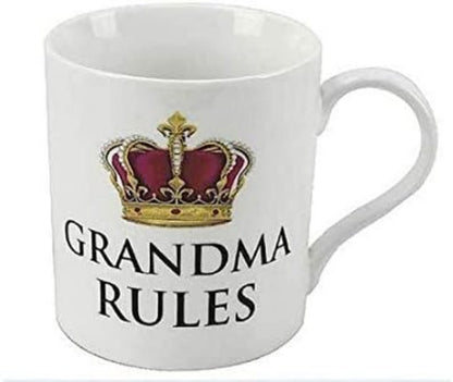 A white ceramic mug featuring a printed gold and purple crown graphic above the words 'GRANDMA RULES' in black capital letters.