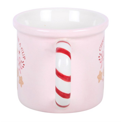Pink ceramic mug with red-and-white candy-cane style handle and side Christmas graphic