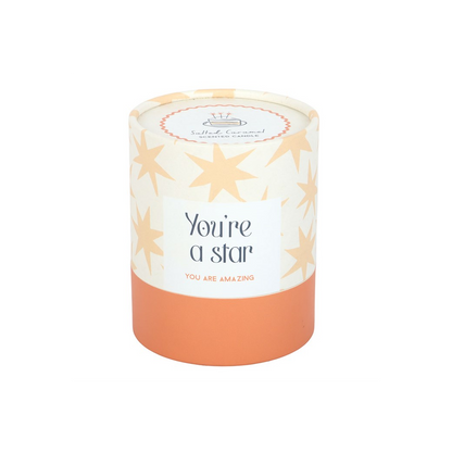 Star-themed candle jar with lid and orange wax base; “You’re a star” label on front