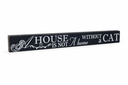 A rectangular black wooden wall sign with white painted text that reads 'A HOUSE WITHOUT a CAT IS NOT a home', displayed on a white background.