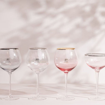 Stemmed gin glasses with gold rims and numbered 25, 30, 40 labels
