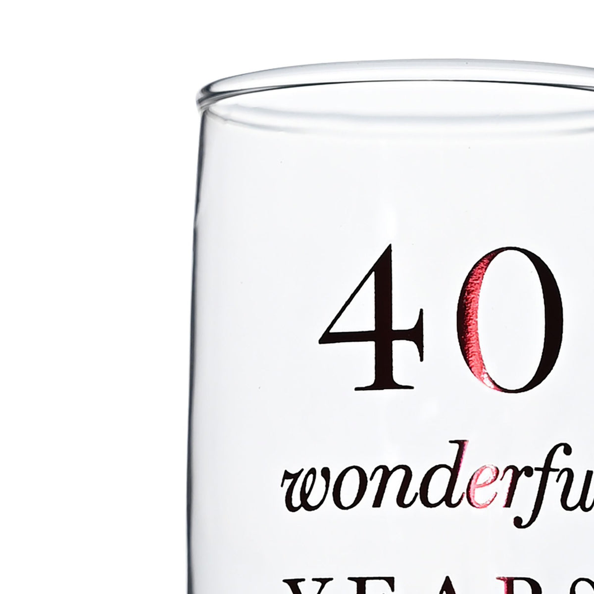 Close-up of clear champagne flute with black '40 wonderful' and red accent