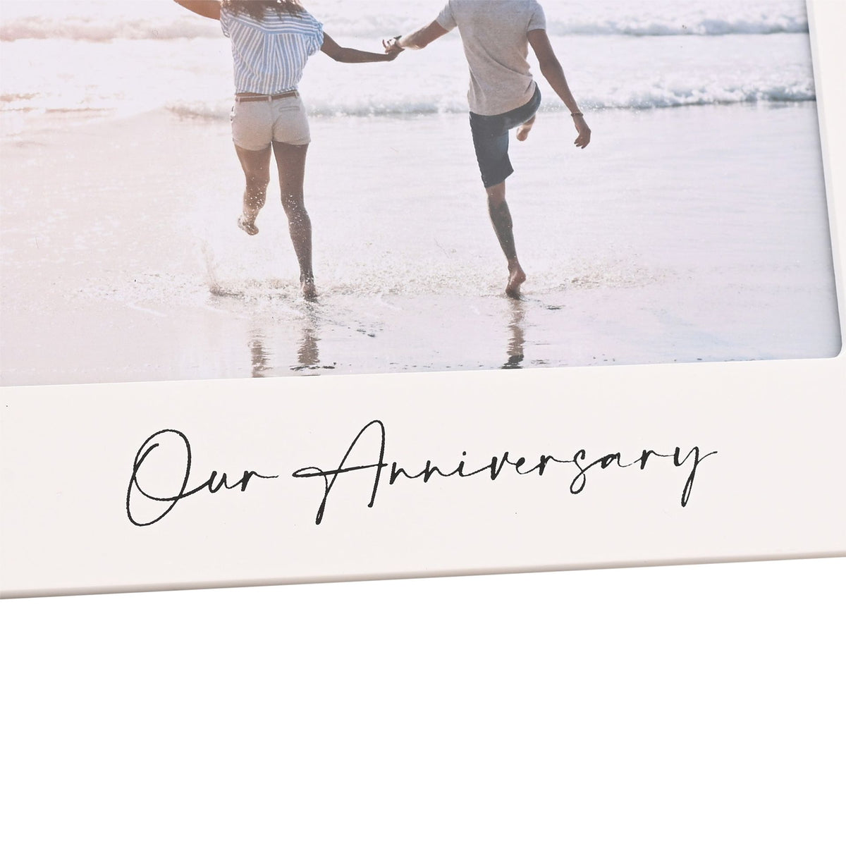 Close-up of white 6x4 anniversary photo frame with 'Our Anniversary' script below couple photo