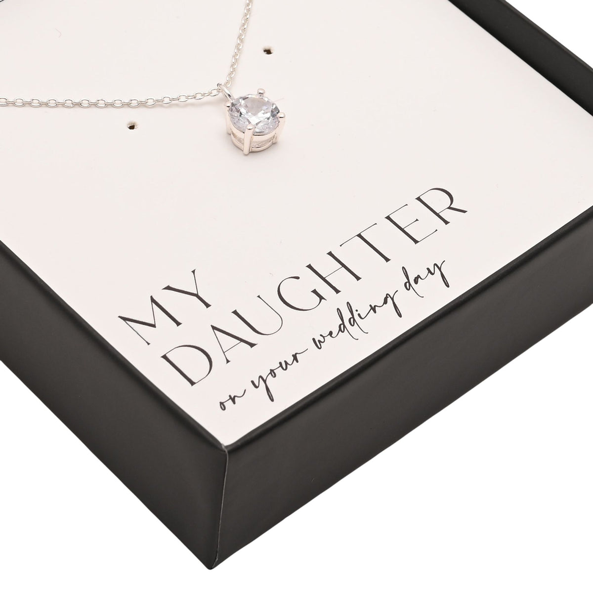 Silver-tone chain necklace with round crystal pendant in gift box corner