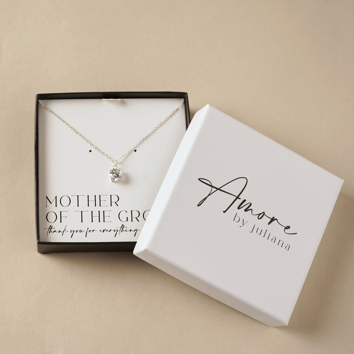 Silver-plated necklace with round crystal pendant, shown in gift box