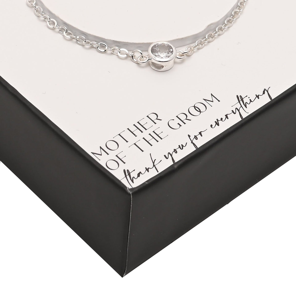 Silver-plated bracelet close-up: round clasp charm with small stone