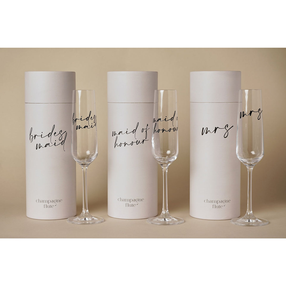 Multiple champagne tube sets with black script labels: brides, maid, maid of honour, mrs.