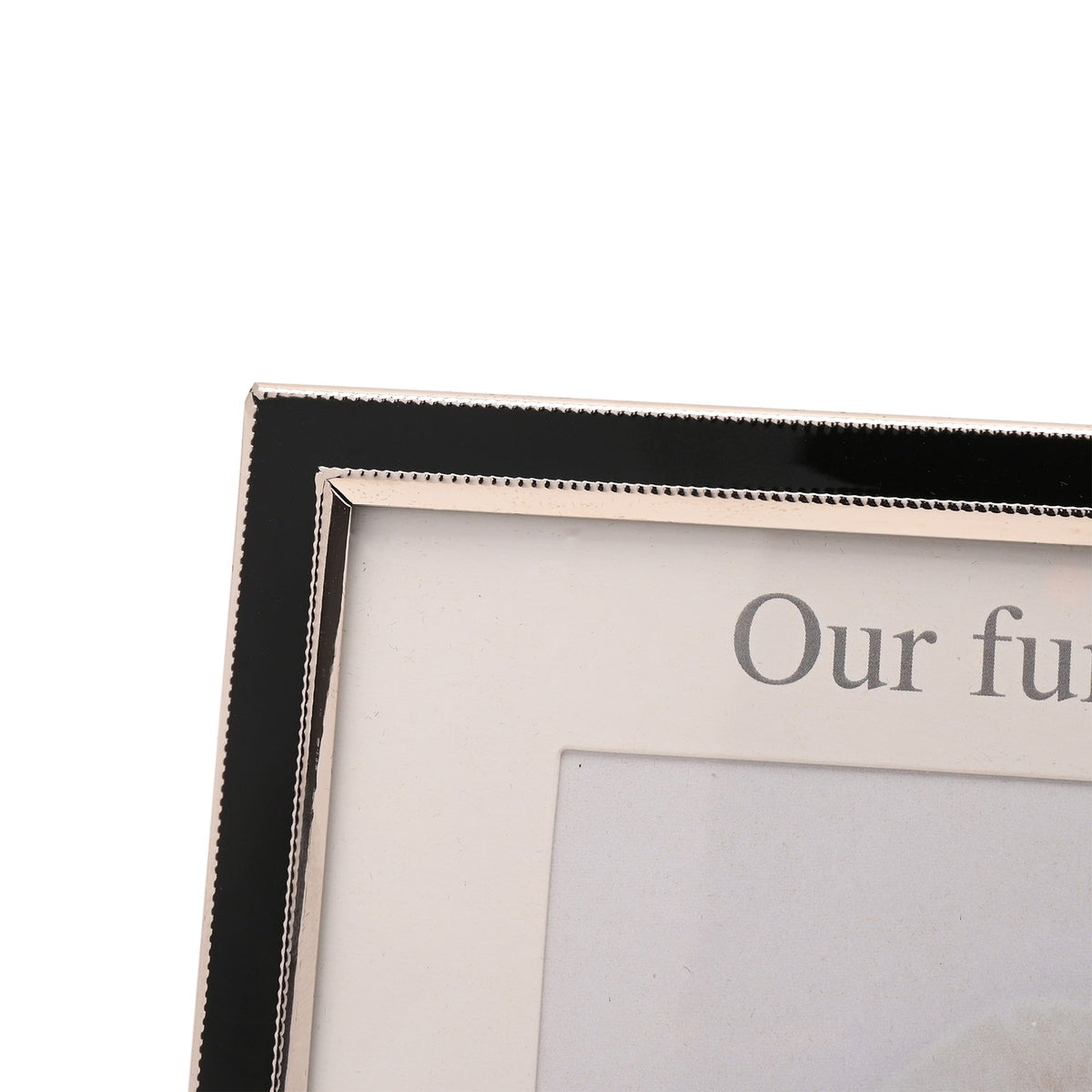 Close-up corner of black two-photo aperture frame with white mat and partial text.