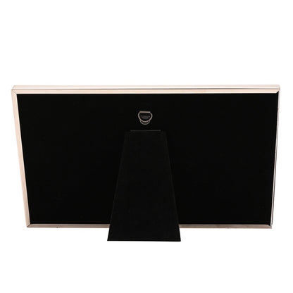 Back of black photo frame with fold-out stand and hanging loop