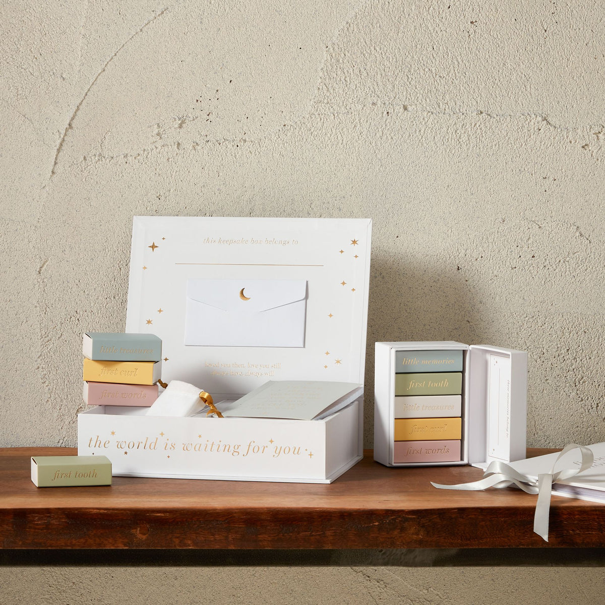 White mini keepsake box set with gold star pattern, open card tray, and ribbon