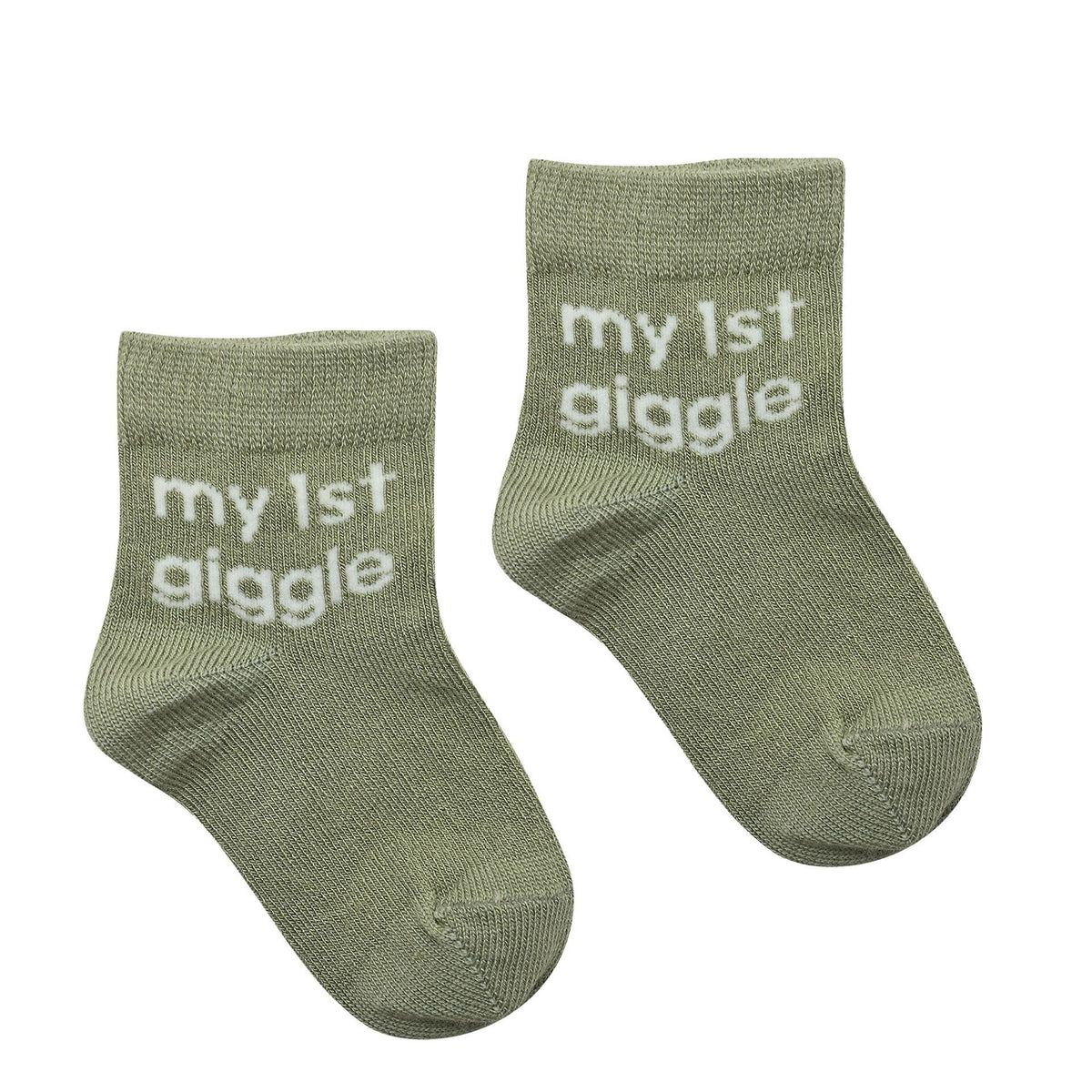 Pair of sage green baby socks with "my 1st giggle" text on cuff