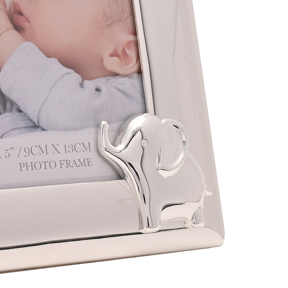Silverplated elephant ornament on the corner of a 4x6 photo frame