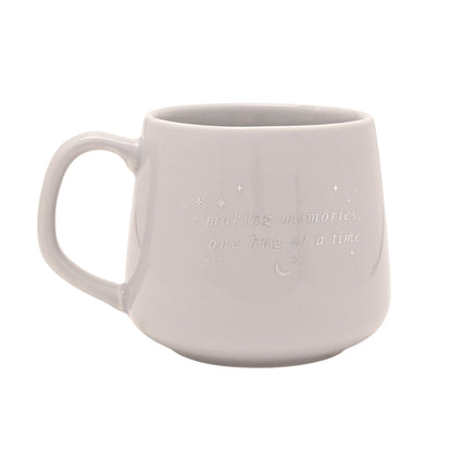 Light gray ceramic mug with handle, “making memories, one hug at a time” print