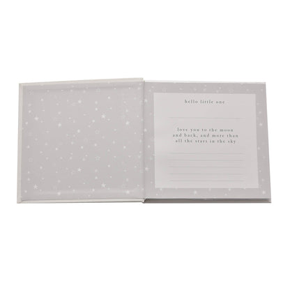 Opened photo album with star-pattern pages and message card