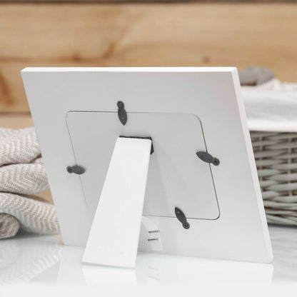 White photo frame with clear window and black star corner accents, table display