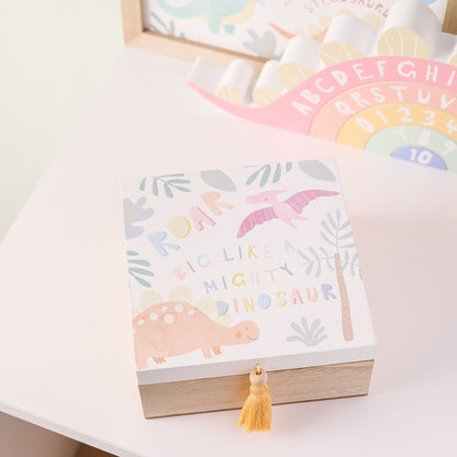 Dinosaur keepsake box lid with pastel text and yellow tassel on wooden base
