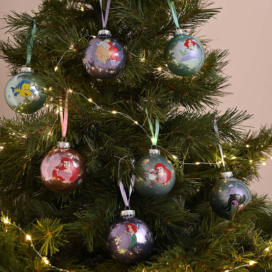 Little Mermaid character baubles hanging on a lit Christmas tree