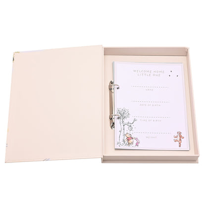 Open milestone album with card insert showing “welcome home, little one” and space for details