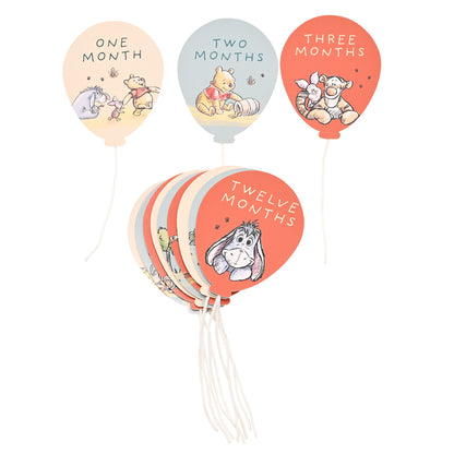 Set of circular month stickers: One, Two, Three, and Twelve Months, with strings attached