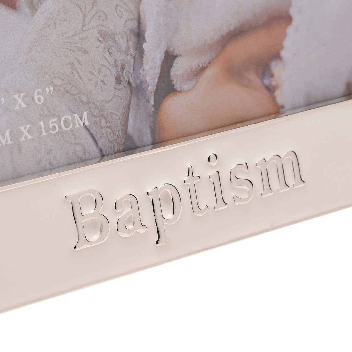 Close-up of raised 'Baptism' word on silver enamel photo frame front.