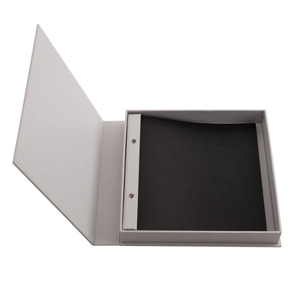 Opened gray scrapbook album with dark interior pages and metal hinge hardware
