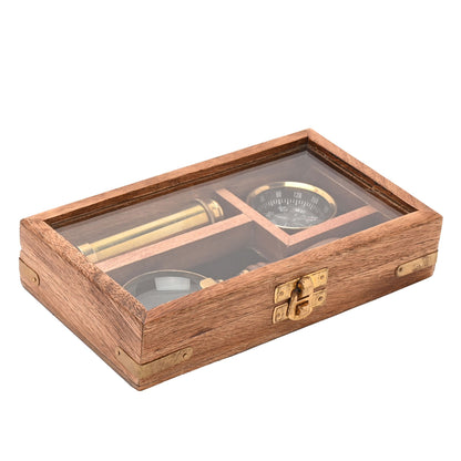 Wooden telescope, compass, and magnifying glass set inside clear window case