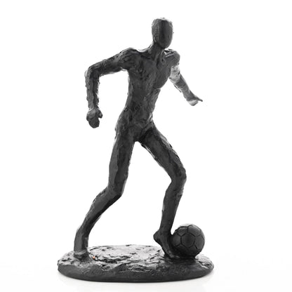 Dark footballer figurine with one leg forward and soccer ball near the base