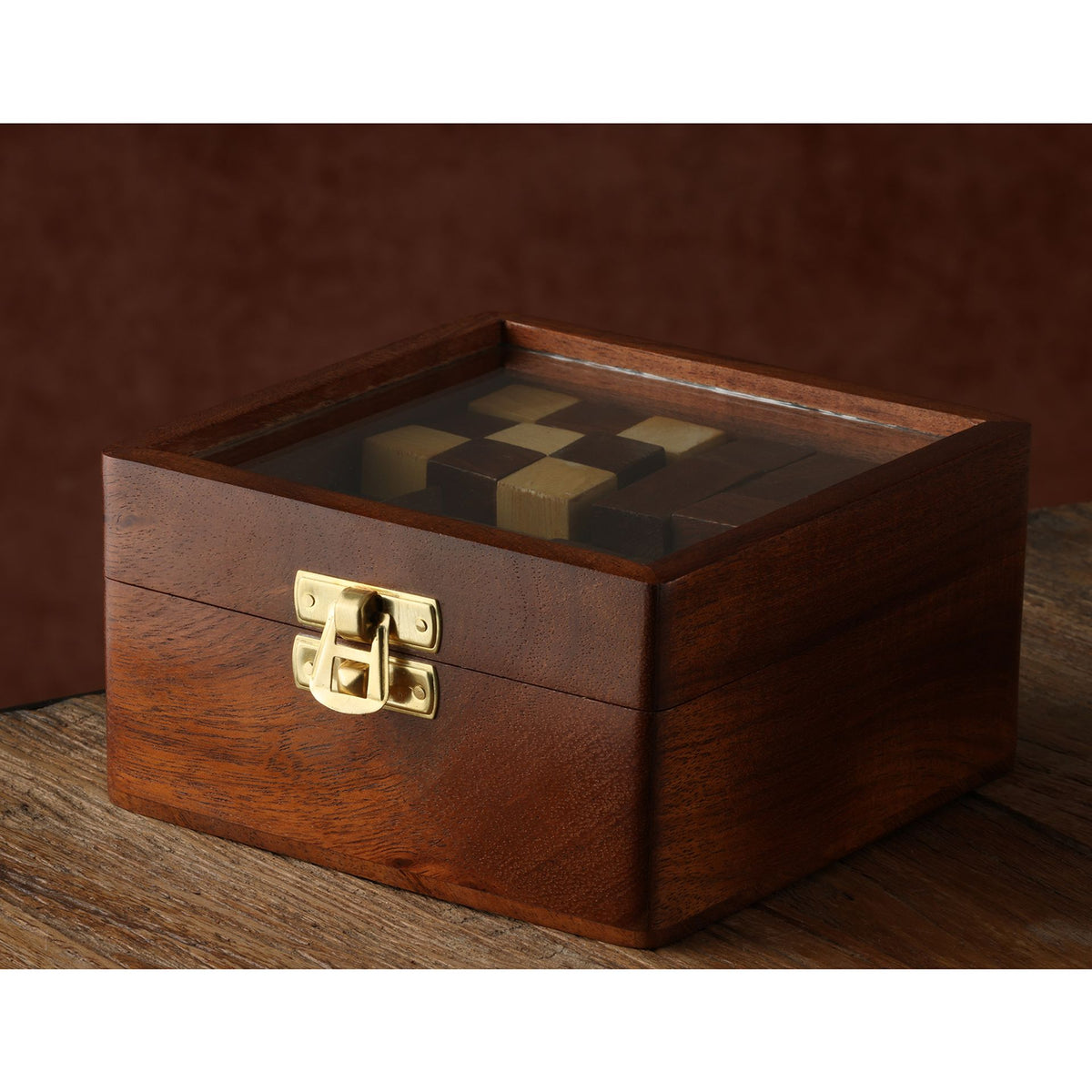 Wooden puzzle box with brass latch and grid of geometric puzzle blocks