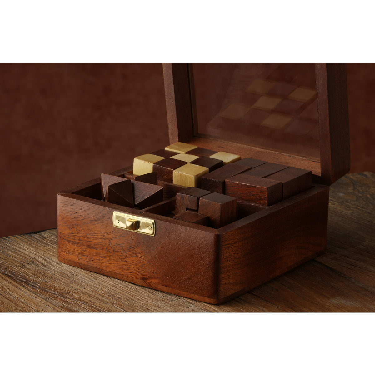 Wooden puzzle box with brass latch and multi-tone geometric puzzle pieces
