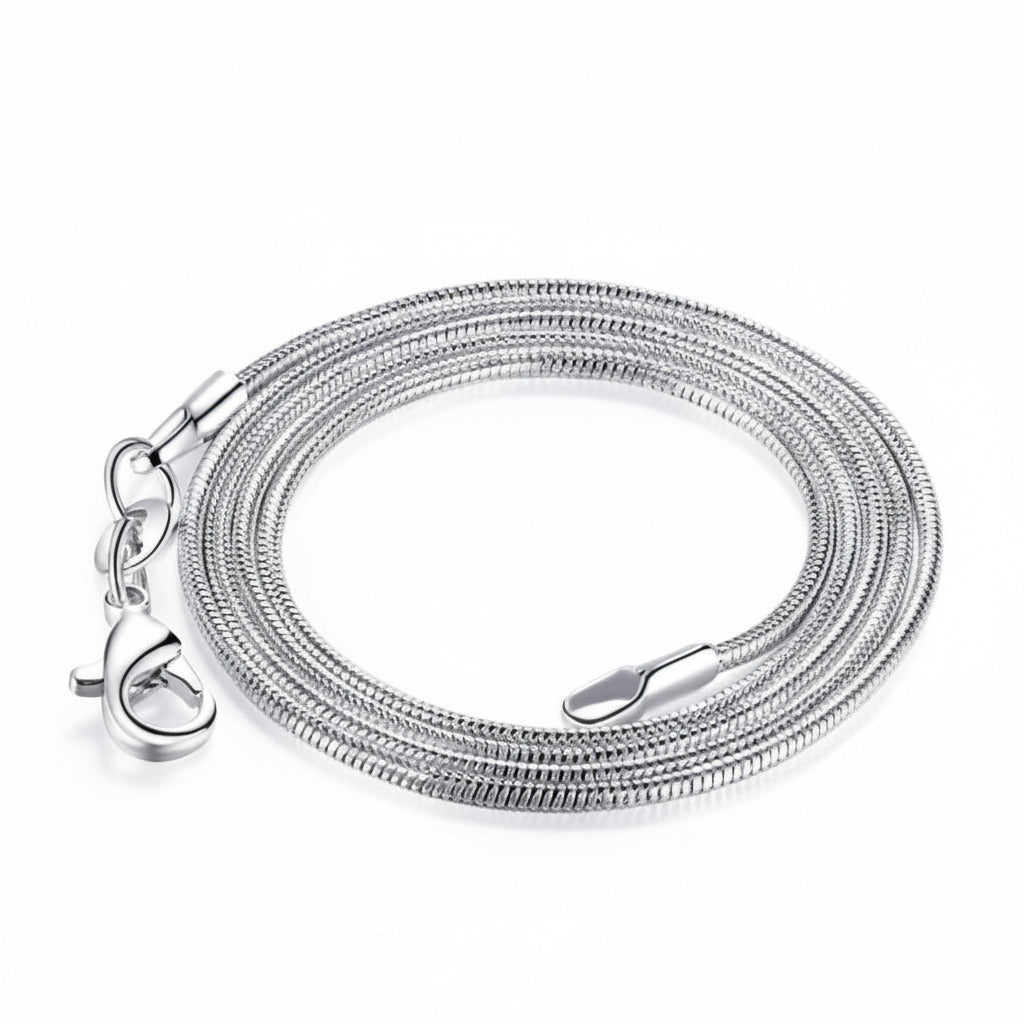 A silver snake chain on a white background.