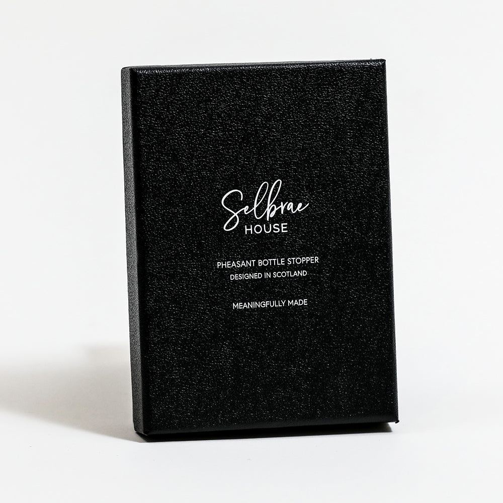 Black gift box for bird bottle stopper with white branding and wording