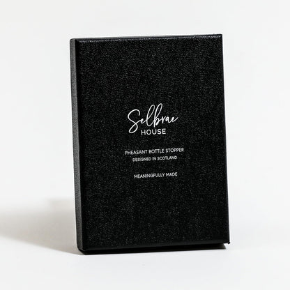 Black gift box for bird bottle stopper with white branding and wording