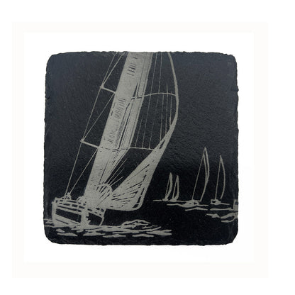 Slate coaster with engraved sailboat design on a white background