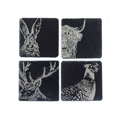 Four black slate coasters featuring white engravings of rabbit, deer, and fawn