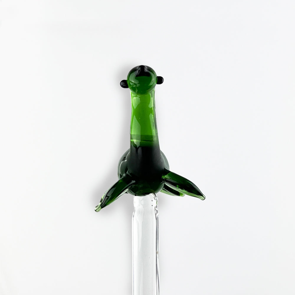 Green glass Nessie drink stirrer with fin-like arms on stir rod