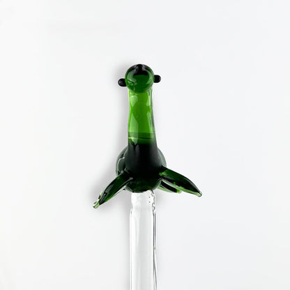 Green glass Nessie drink stirrer with fin-like arms on stir rod