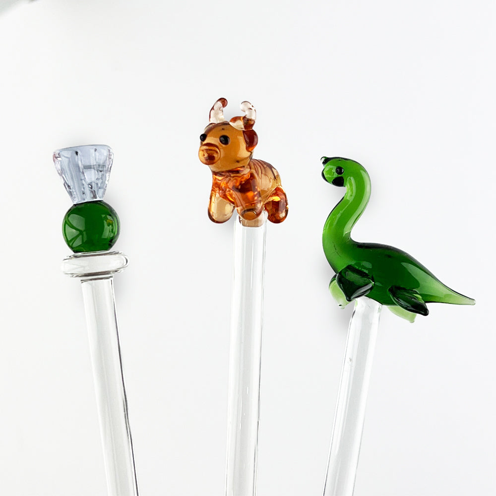 Glass drink stirrers with green Nessie and two animal heads on clear rods