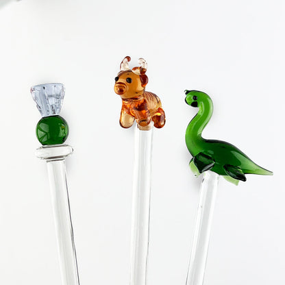 Glass drink stirrers with green Nessie and two animal heads on clear rods